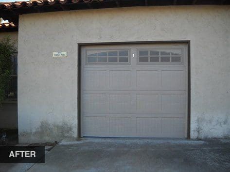 Gray garage door on stucco house.