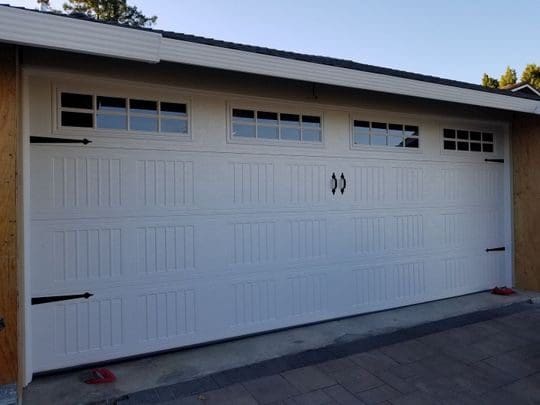 White garage door with windows and black hardware.