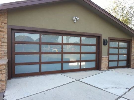 Double garage doors with frosted glass panels.