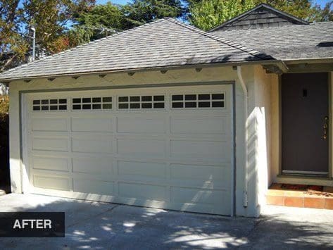 White garage door with windows after renovation.