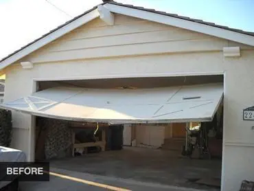 A broken garage door before repair.