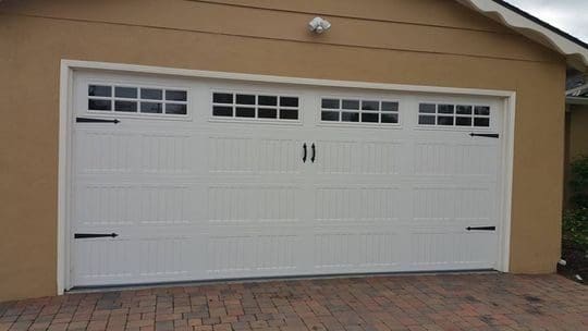 White garage door with black handles.