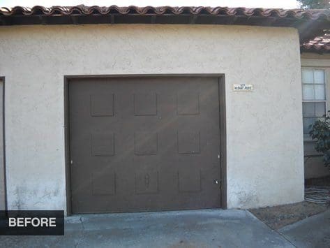 Garage door before renovation with white trim.